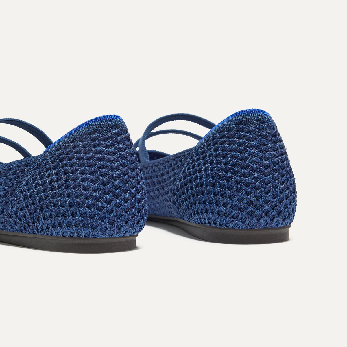 Close up of the heel of The Double Buckle Mary Jane in Blue Mesh, with Rothy's signature blue halo.
