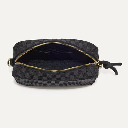 The Crossbody Camera Bag in Black Sand, shown from above, with the interior exposed.