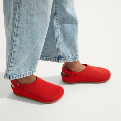 hover | A child wearing The Kids Clog in Firetruck Red.