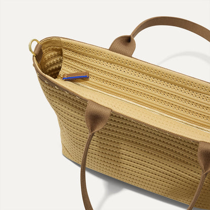 The Lightweight Zip Tote in Brown Butter Crochet, focusing on the zip closure and handles